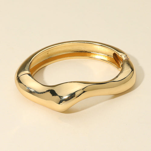 Sculptural gold hinged bracelet